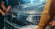 Paint Protection Film or PPF polymer protection coating layer, installing and wrapping on car hood in Detailing Garage.