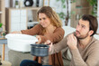 © auremar - couple catching leaking water in a basin and saucepan