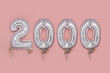 Balloon Bunting for celebration of 2000 made from Silver Number Balloons on pink background. Holiday Party Decoration or postcard concept with top view