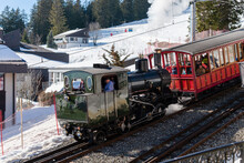 Cogwheel Locomotive Train Operating From Lake Lucerne To The Top Of Rigi Alpine Ski Resort. Historic Old Vintage Cogwheeel Steam Train In Winter On Rigi Mountain Ski Resort, Switzerland