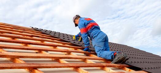 Man worker uses a power drill