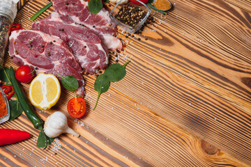 Wall Mural - Raw pork chop steak prepare in kitchen with vegetable and spices for food and cooking concept.