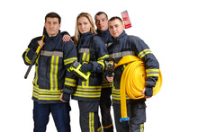 Group Of Young Brave Firefighters In Uniform Holds Sledgehammer, Flashlight, Axe And Fire Hose In Hands And Looking At Camera Isolated On White Background