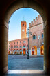 14 february 2021, Treviso, Italy: View of Piazza dei Signori (Lord's Square) through an arch. the background the Palace of the Prefecture and the Civic Tower