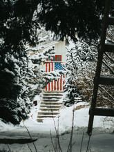 Snow Covered American Flag On A Residential Home In Colorado