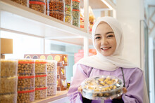 Beautiful Shop Owner Muslim Woman Holding Some Cake For Eid Mubarak In Her Store