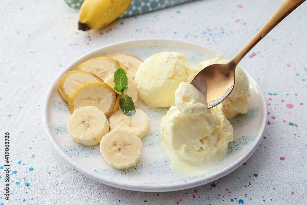 Plate with tasty banana ice-cream on light background, closeup