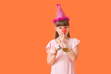 Poster - Little girl in funny disguise and with paper fish on color background. April Fools Day celebration