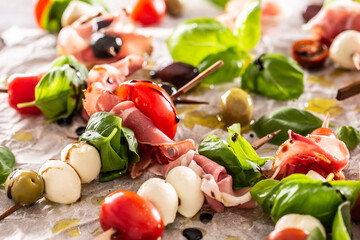 Wall Mural - Caprese skewers italian or mediterranean appettizer tomatoes mozzarella olives and prosciutto