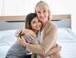 © Bangkok Click Studio - Caressing woman embracing adopted daughter
