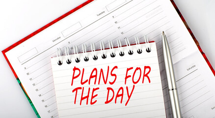 Poster - Close-up of diary , notebook and pen on the white background with text plans for the day