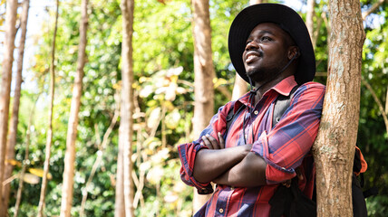 Happy Africa American hipster man backpack in nature public park and find location for camping, Relax time on holiday concept travel. Travel and Hiker concept