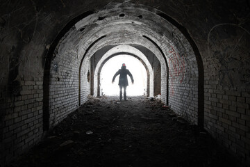 Wall Mural - terrible silhouette of a man with two burning lights on his head, with outstretched arms at the entr