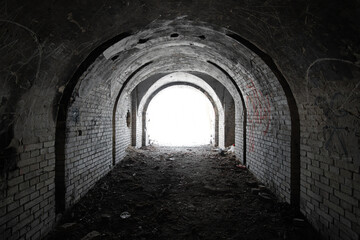 Wall Mural - exit from the old dark brick arched tunnel of the 19th century fortification. light in the end of ol