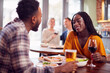 © Monkey Business - Smiling Young Couple On Date Enjoying Pizza In Restaurant Together