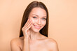 © deagreez - Photo of young girl happy positive smile enjoy cosmetology procedure collagen cream isolated over beige color background