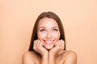 © deagreez - Portrait of charming cheerful girl looking up copy empty space pamper isolated over beige pastel color background
