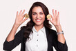 Happy businesswoman showing bitcoin coins