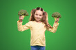 Happy kid demonstrating fresh broccoli