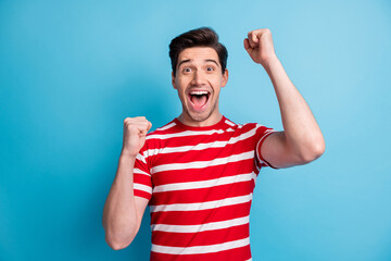 Poster - Photo of impressed cute sweet lucky funny guy dressed red clothes open mouth rising fists isolated blue color background