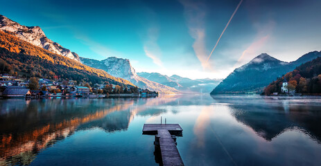 Fotomurali - Amazing autumn scene of Grundlsee lake. Austria. Colorful morning view of calm alpine lake with colorful sky over the mountains. Iconic location for landscape photographers and blogers. Creative image