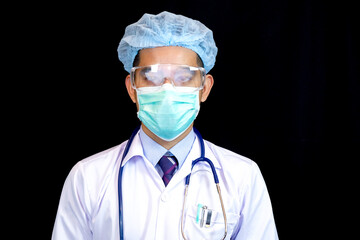 Portrait of confident young medical doctor on black background.