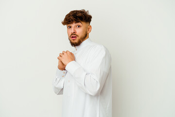 Wall Mural - Young Moroccan man wearing a typical arab clothes isolated on white background scared and afraid.