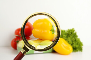Wall Mural - view through magnifying glass on vegetables, closeup. poison detection