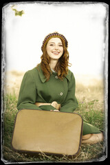 Sticker - Redhead girl with suitcase sitting at autumn grass