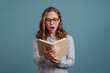 © Drobot Dean - Shocked young woman reading a book
