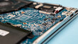 © Volodymyr - Close up laptop without cover inside disassembling in repair shop. Computer service engineer technician workplace repairing fixing broken components upgrade system, microelectronics maintenance