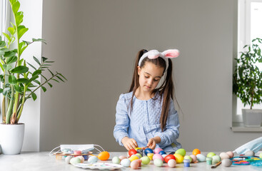 A girl showing her painted Easter Egg