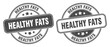 © Aquir - healthy fats stamp. healthy fats label. round grunge sign