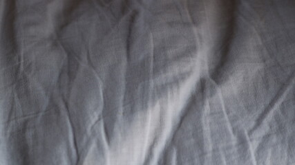 Wall Mural - wrinkled cotton fabric lying on a flat surface with textured drapery, graphic resource with empty space, light gray fabric with folds, shadows and stripes texture, light and minimalistic backdrop