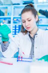 Canvas Print - Young female laboratory assistant in laboratory analyzing environmental pollution