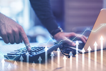 Stock market analysis concept with digital graphs and arrows and businessman using calculator and laptop on background