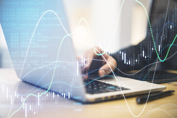 Forex trade market analysis concept with businessman working on laptop and digital screen with financial chart with diagram