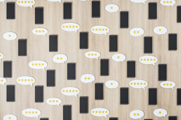 Poster - Social network rating concept with black cell phones on wooden surface and speech bubbles with stars