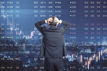 Poster - Crisis and bear stock market concept with businessman grabs his head in front of digital stock board with falling financial graphs and market quotes