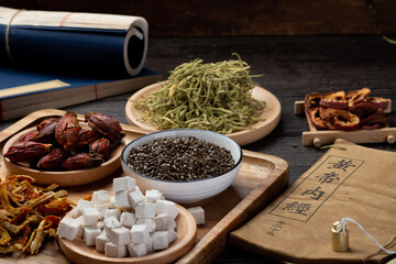 Ancient Chinese medicine books and herbs on the table.English translation：Emperor's Internal Classic