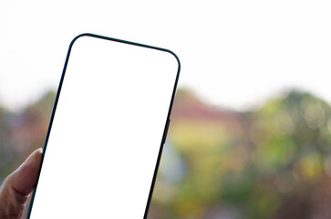 Smartphone handle, white, and a blank screen for design and message. Concept of new phone technology Takes closeup with a blurred background. The screen of the mobile device is blank, clipping pat