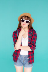 Wall Mural - Beautiful portrait young asian woman wear sunglasses and hat having backpack smile confident enjoy summer holiday isolated blue background, tourist model girl thinking idea planning travel concept.