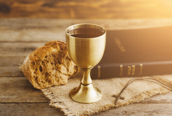 Sticker - Chalice of wine with bread and Holy Bible on wooden background