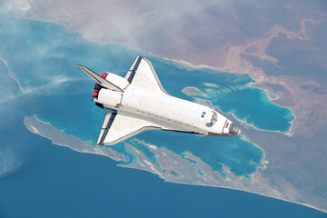 Poster - Spacecraft shuttle flies over the beautiful overhead view of the planet Earth with the sea and islands. Space rocket in the sky fly over the mainland explores space and planets. Aerial Shot