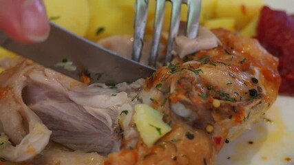 Wall Mural - close-up of eating chicken with a knife and fork. delicious beautiful baked chicken with potatoes Baked chicken wings served with different sauces and lemon