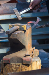 Wall Mural - blacksmith performs the forging of hot glowing metal on the anvil