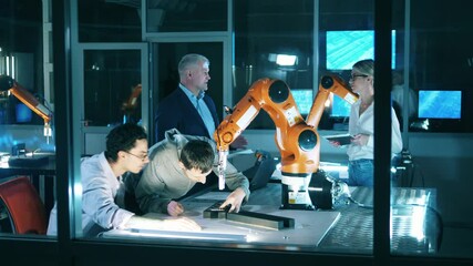 Wall Mural - group of scientists are working together in a robotics laboratory