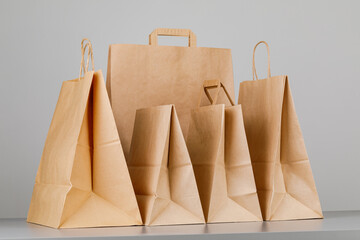 Wall Mural - Brown paper bag with handles, empty shopping bag with area for your logo or design, food delivery concept.