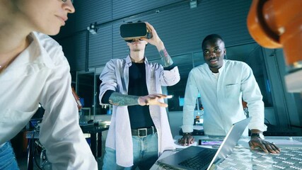 Wall Mural - group of scientists are operating a robot through virtual reality