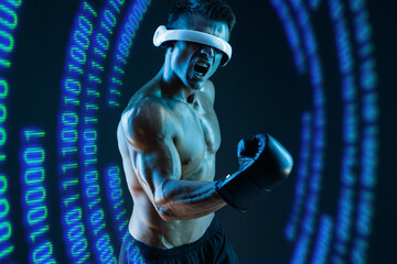 Muscular model sports young man in glasses of virtual reality and boxing gloves. Blue neon light. Futuristic holographic interface to display data. Augmented reality, future technology, game concept.